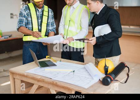 engineer brainstorming and measuring for cost estimating on blueprint ...
