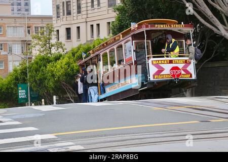 San Francisco cable car descending a hill in Powell Street San Francisco California USA Stock Photo