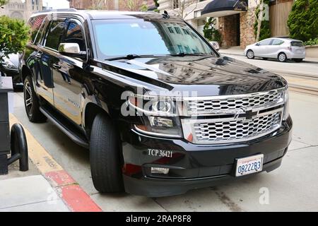 Black Chevrolet Suburban SUV Midnight Edition car parked in the street in San Francisco California USA Stock Photo