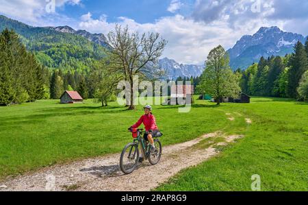 active senior woman on a mountain bike tour in the Julian Alps above Kranska Gora in Slovenia Stock Photo