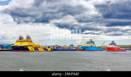 Montrose Scotland River South Esk the harbour three large colourful oil rig support vessels Stock Photo