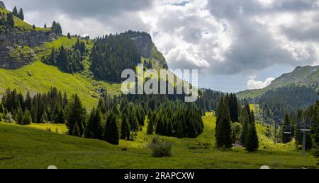 Mountain range around Montriond lake in French Alps near Les Gets with leisure melt water pond during summer. Environment and climate concept Stock Photo