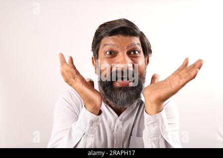 Portrait of Indian bearded man surprised. Funky expressions portraying sense of accomplishment and achievement. Feeling proud of executing things. Stock Photo