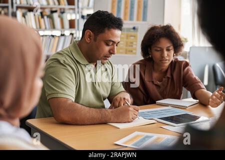 Group of multiethnic students learning foreign language together in class Stock Photo