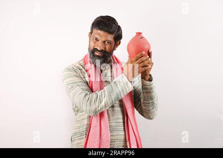 Portrait of happy Indian bearded farmer man in rural India concept. various expressions white background. Villager future saving money in piggy bank. Stock Photo