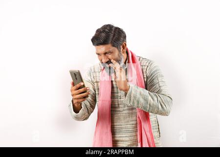 Cheerful Indian bearded farmer doing a video call and using internet and technology. Awareness of digital and internet. go digital. Stock Photo