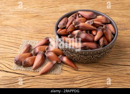 Pinions or pine tree seeds on a bowl over wooden table. Stock Photo
