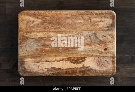 Rustic textured mango wood chopping board with copyspace for text, flat lay Stock Photo