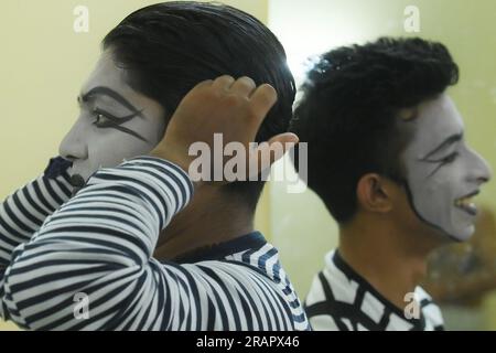 Mime artists from a mime group,'Sur-Pancham', are getting ready for a performance in a green room of an auditorium at Agartala. Tripura, India. Stock Photo