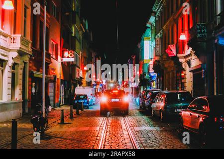 A car driving in the night european old town on cobblestones and tram tracks in Antwerp,Belgium Stock Photo