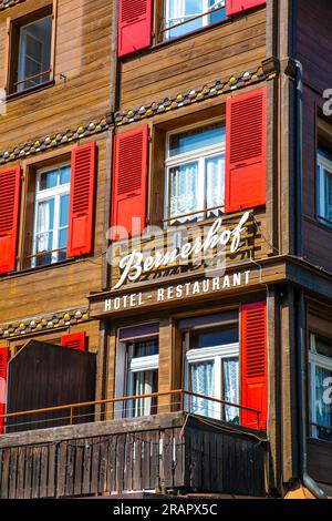 Exterior of Swiss style chalet hotel Bernerhof with red shutters on the main street (Dorfstrasse) in Wengen, Switzerland Stock Photo