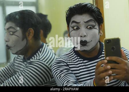 Mime artists from a mime group,'Sur-Pancham', are getting ready for a performance in a green room of an auditorium at Agartala. Tripura, India. Stock Photo