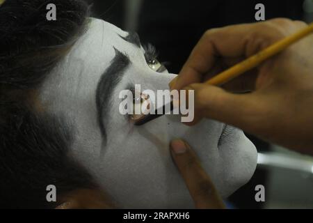 Mime artists from a mime group,'Sur-Pancham', are getting ready for a performance in a green room of an auditorium at Agartala. Tripura, India. Stock Photo