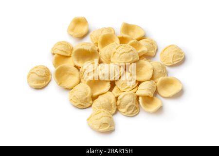 Heap of uncooked Orecchiette pasta close up isolated on white background Stock Photo