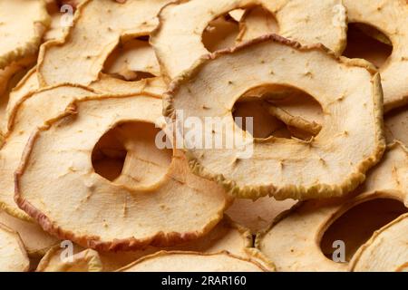 Dried apple chips full frame close up as background Stock Photo