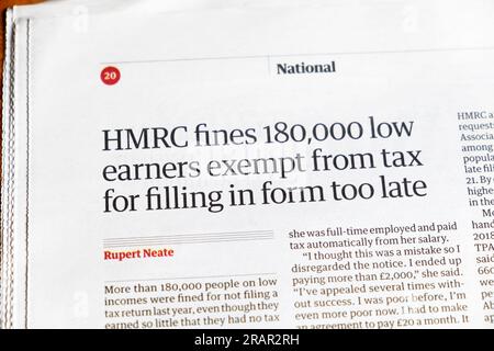 'HMRC fines 180,000 low earners exempt from tax for filling in form too late' Guardian newspaper headlines headline 27 June 2023 London England UK Stock Photo