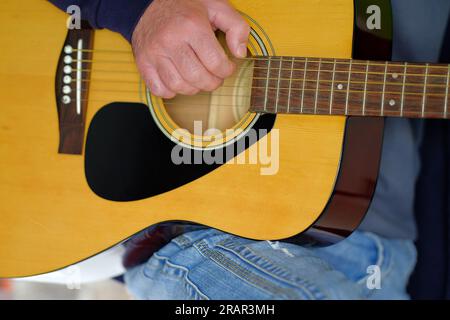 Close-up shot of a guitarist playing a classical guitar. Stock Photo