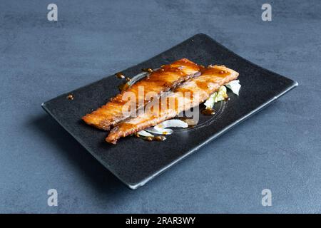 Sushi restaurant, view of a Japanese dish, Sake Teppanyaki. Stock Photo