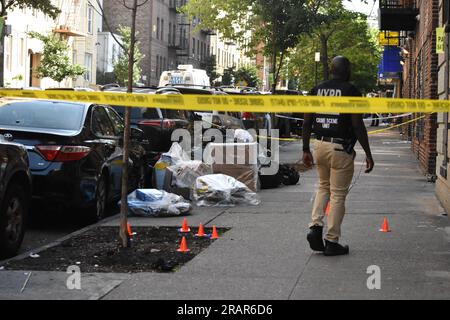 Crime scene investigation scours the crime scene, in a daylight search for evidence. Double shooting in Bronx, New York, United States on July 5, 2023. Wednesday morning at approximately 2:21 AM Eastern Time, police responded to a 911 call of two males shot at 2256 Morris Avenue, within the confines of the 46 Precinct. Upon arrival officers observed an 18-year-old male with a gunshot wound to the leg and 19-year-old male with a gunshot wound to the hip. The 18-year-old male was transported by EMS to Saint Barnabas Hospital where he was pronounced deceased. The 19-year-old male was transported Stock Photo