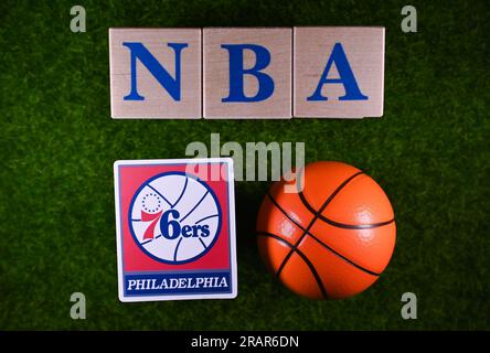 January 30, 2023, Springfield, USA. The emblem of the Philadelphia 76ers National Basketball Association club on the green lawn of the stadium. Stock Photo