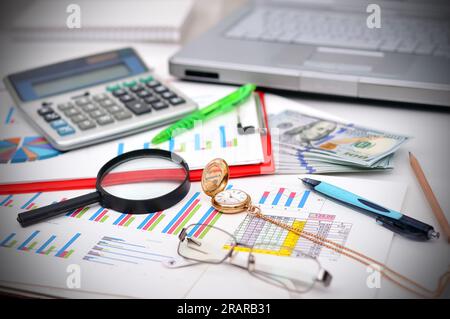 Close-up of business document, pocket watch, money and calculator  on desk Stock Photo