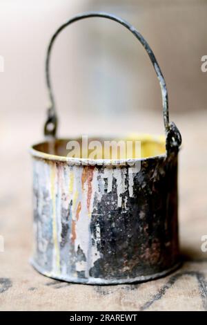 Vintage Paint Can with Artistic Paint Splatter On a Wooden Surface Stock Photo