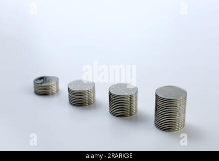 Four stacks of coins with white background. concept of business planning and bar chart Stock Photo