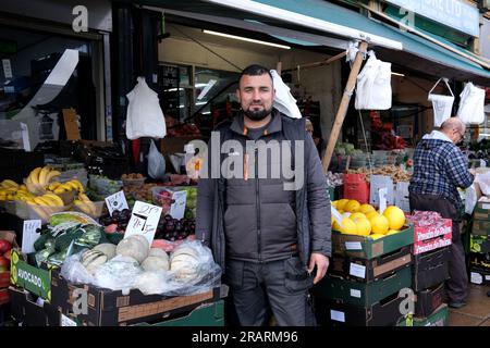 Street market stall holder outside his fresh fruit and vegetable shop in Smethwick, West Midlands, Britain, Uk Stock Photo
