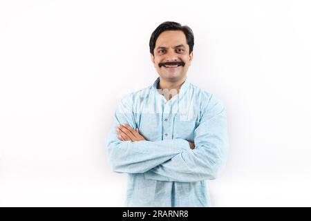 Happy Indian farmer in rural India concept. Standing in the white background, the passionate farmer full of enthusiasm is happy and ready to achieve. Stock Photo