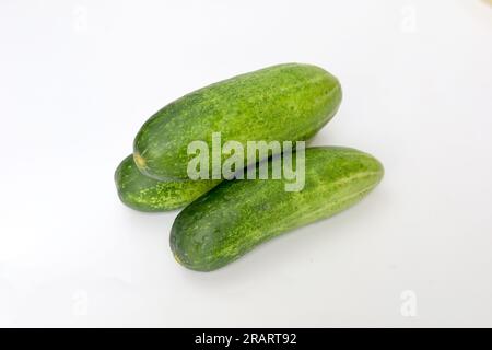 Fresh green and healthy cucumbers on wooden board Stock Photo