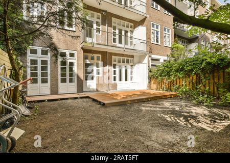 a house that is in the process of being remodeled and renovated with new siding, wood decking and landscaping Stock Photo