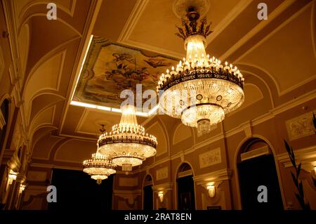 luxurious decorative crystal chandeliers emitting light in warm tones Stock Photo