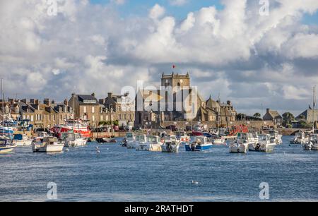 harbour of the pituresque fishing village of Barfleur on the Cotentin Peninsula with view of ancient Nicolas de Barfleur church, department of Manche, Stock Photo