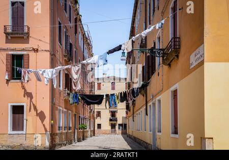 Clothes laundry left to dry at the window of a old medieval building in Venice, Italy Stock Photo