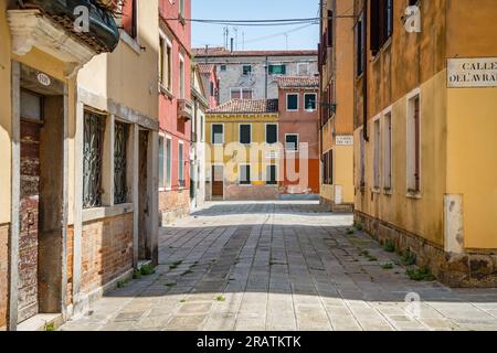 Scene with the narrow streets and the old medieval red brick buiuldings in Venice, Italy. Stock Photo