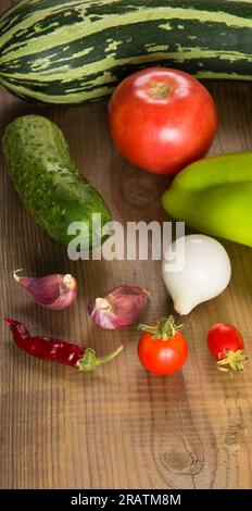 A set of vegetables on a wooden table. Vertical photo. Stock Photo