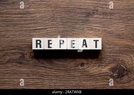 Repeat - word concept on building blocks, text Stock Photo
