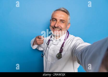 Telemedicine and Virtual Consultations. Handsome middle aged doctor using digital tablet to conduct remote appointments, diagnose patients, provide me Stock Photo