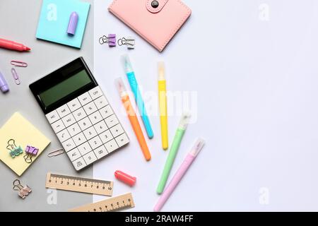 Modern calculator with different stationery on color background Stock Photo