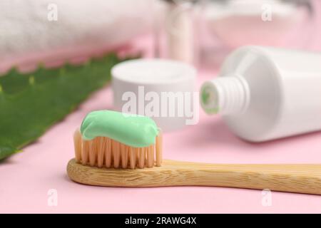 Toothbrush with aloe toothpaste on pink background, closeup Stock Photo