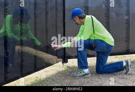 Family member remembering Vietnam War Veteran, Vietnam Memorial Traveling Wall, Texas, Stock Photo