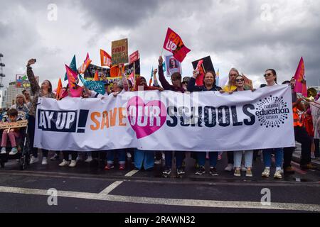 London, UK. 05th July, 2023. Protesters march with a 'Save our schools' banner during the demonstration on Westminster Bridge. Thousands of teachers marched in Westminster as the National Education Union (NEU) stage fresh strikes over pay. Credit: SOPA Images Limited/Alamy Live News Stock Photo
