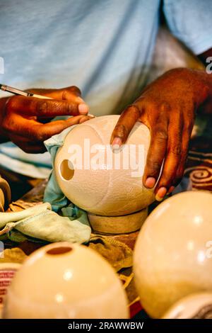 african craftsman carving traditionally by hand an ostrich shell Stock Photo