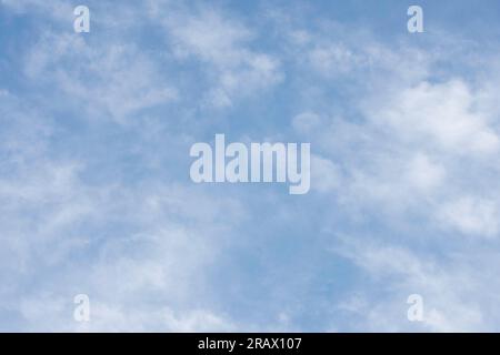 Sky background of cirrocumulus clouds visible in late afternoon against a blue sky. Stock Photo