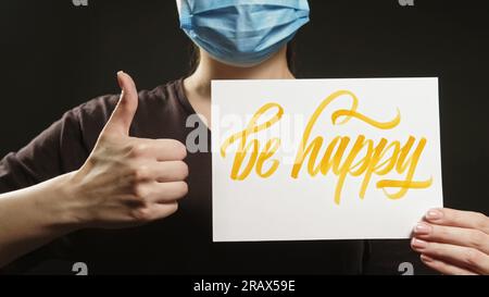 Be happy health motivation woman mask thumb up Stock Photo