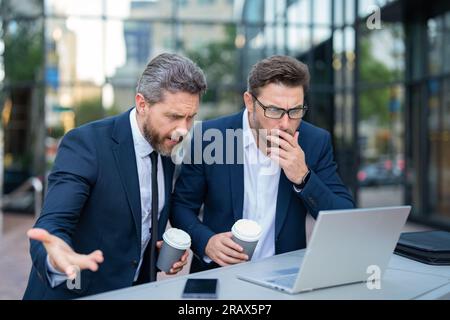photo of amazed trader men freelancing online. two trader men freelancing online. Stock Photo