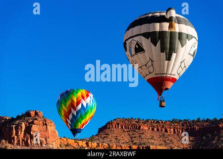 Hot air balloons rise above the mountain Stock Photo