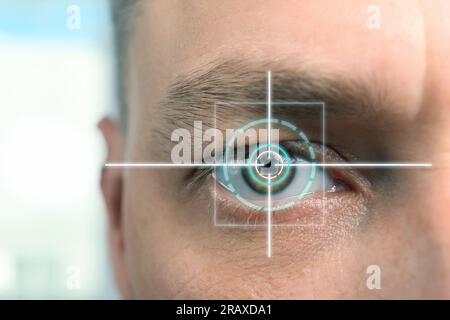 Vision test. Laser reticle focused on man's eye, closeup Stock Photo