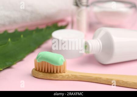 Toothbrush with aloe toothpaste on pink background, closeup Stock Photo