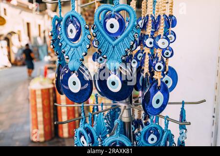Evil eye turkish bead amulets hanging in souvenir store. Gift and superstitions concept Stock Photo